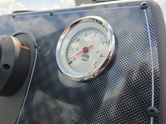 Slide: The Image of Close-up of a tachometer on a boat panel with a carbon fiber look. - 28