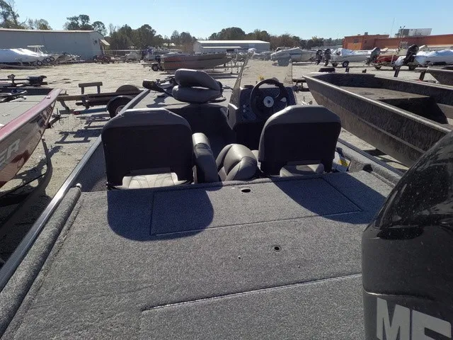 Slide: The Image of The image shows a 2026 Tracker Bass Tracker Classic XL boat on dry land with other boats in the background. - 9