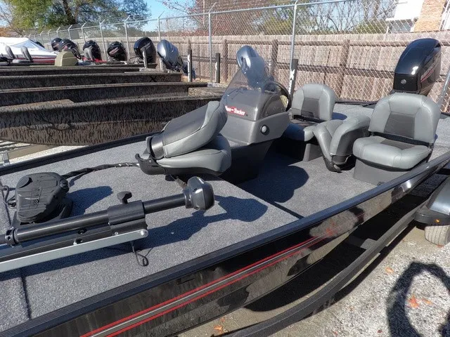 Slide: The Image of 2026 Tracker Bass Tracker Classic XL with gray seats and fishing gear on a trailer. - 4