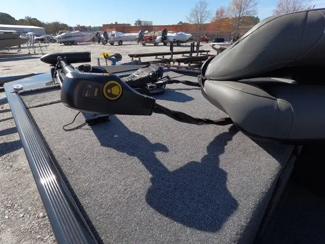 Slide: The Image of 2026 Tracker Bass Tracker Classic XL with gray carpeted deck and seat, parked outdoors. - 5