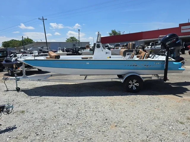 Slide: The Image of A 2026 Xpress SW20B boat on a trailer in a parking lot. - 10
