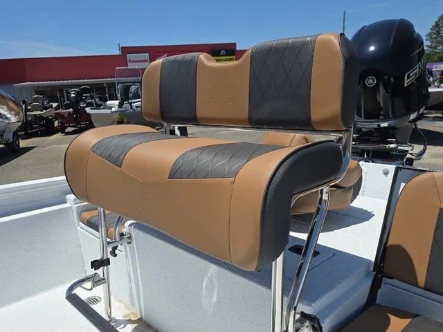 Slide: The Image of The image shows the upholstery of a 2026 Xpress SW20B boat with a brown and black design. - 19