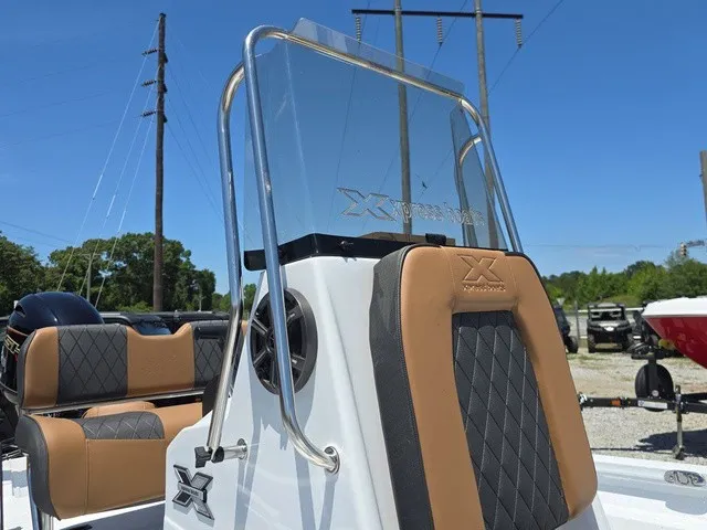 Slide: The Image of The image shows the cockpit of an Xpress SW20B boat with brown and black seating. - 34