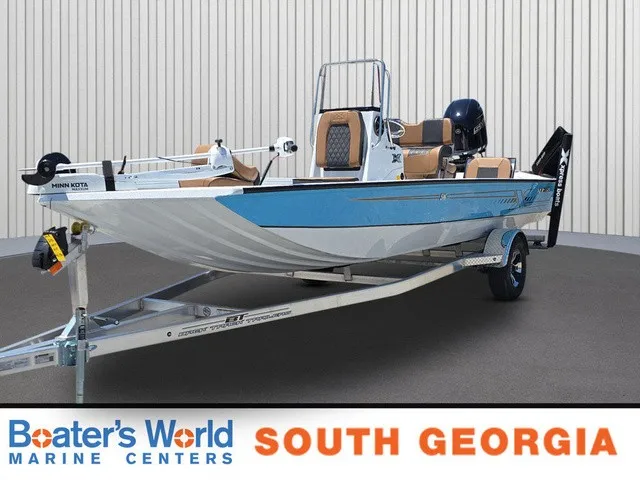 The Image of A blue and white 2026 Xpress SW20B boat on a trailer in a showroom. - 1