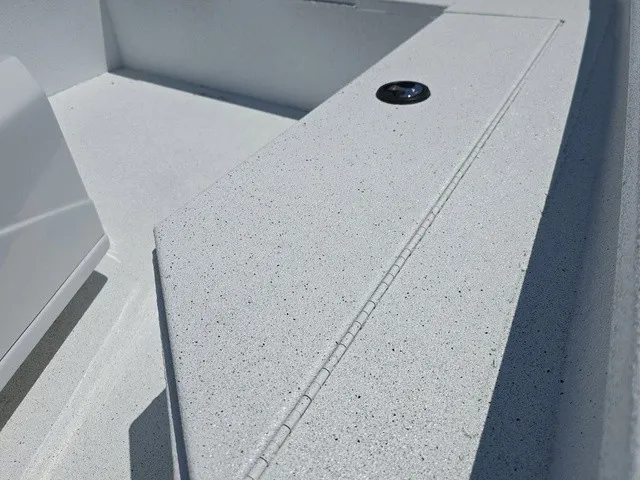 Slide: The Image of Close-up of the deck of a 2026 Xpress SW20B boat, featuring textured flooring. - 23