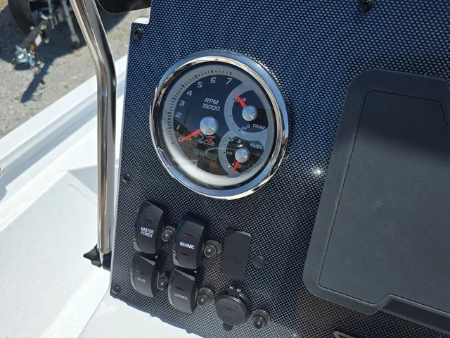 Slide: The Image of Dashboard of an Xpress SW20B boat with a tachometer and switches. - 26