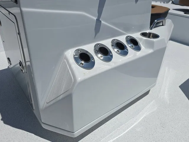 Slide: The Image of Close-up of a boat console area with four round mounts and a cup holder. - 21