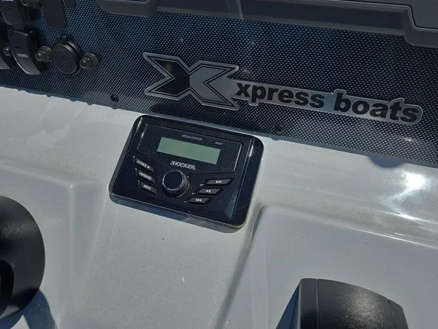 Slide: The Image of Close-up of a console with Xpress Boats logo and a control unit. - 24