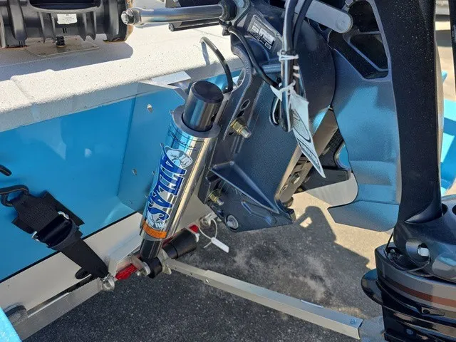 Slide: The Image of Close-up of a boat motor with blue casing and hydraulic system. - 36