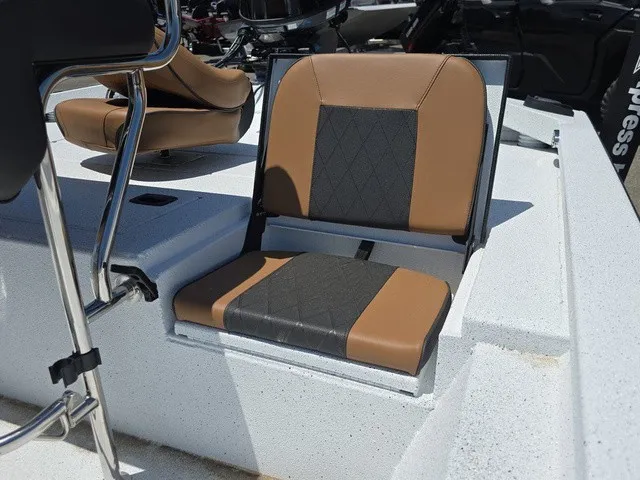 Slide: The Image of A seat on a 2026 Xpress SW20B boat with brown and black upholstery. - 18