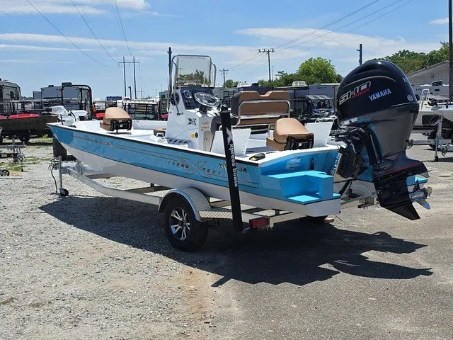 Slide: The Image of A 2026 Xpress SW20B boat on a trailer, featuring a Yamaha outboard motor. - 9