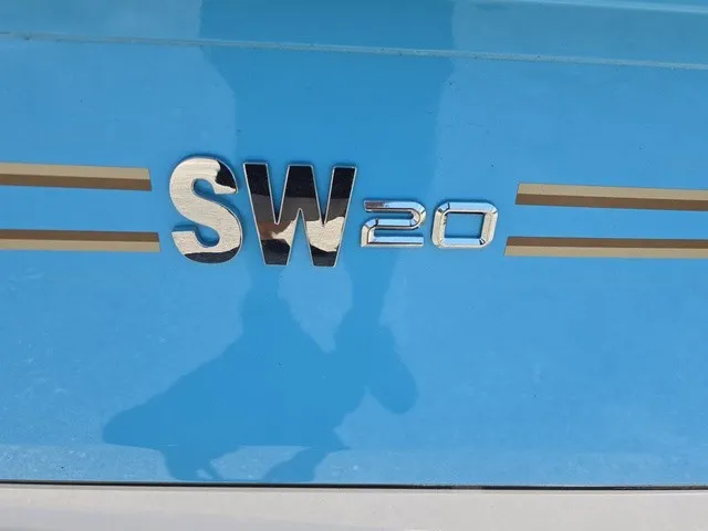Slide: The Image of Close-up of the Xpress SW20B logo on a blue background with gold stripes. - 33