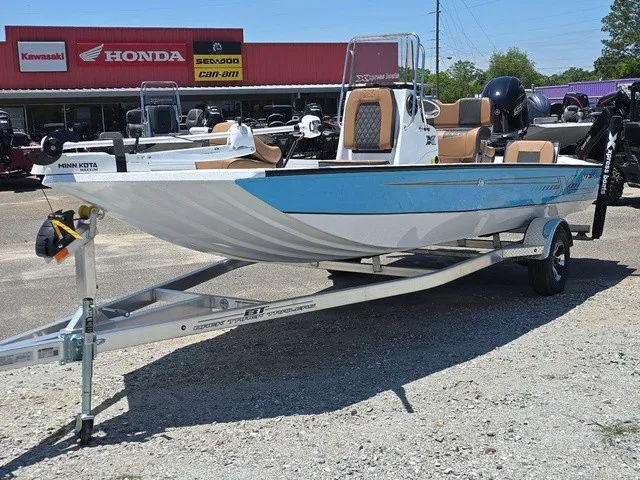 Slide: The Image of A 2026 Xpress SW20B boat on a trailer, featuring a blue and white paint job and outboard motor. - 3