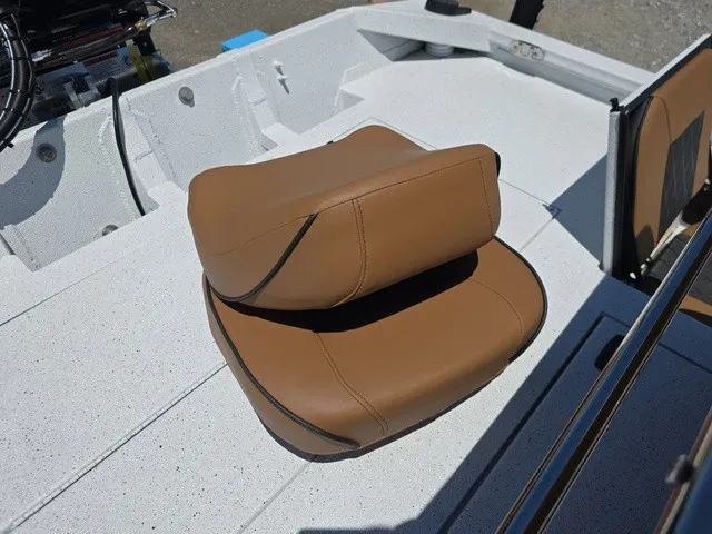 Slide: The Image of Brown cushioned boat seat on a white deck, with stainless steel railing in the background. - 28