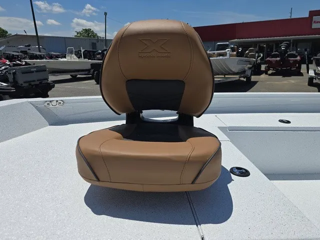 Slide: The Image of A brown cushioned boat seat on a white deck, surrounded by other boats outdoors. - 13
