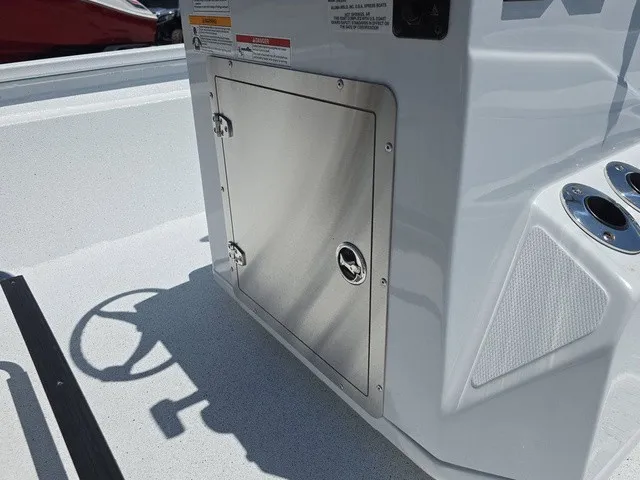 Slide: The Image of A stainless steel storage compartment on a 2026 Xpress SW20B boat, surrounded by white surfaces. - 22