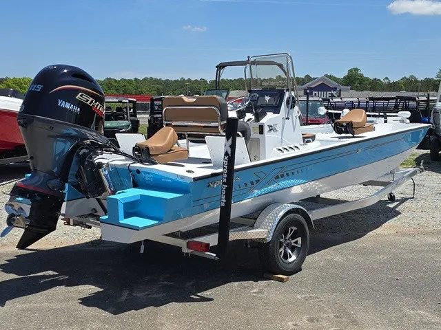 Slide: The Image of A 2026 Xpress SW20B boat with a blue hull and Yamaha outboard motor. - 7