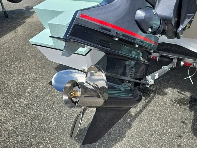 Slide: The Image of Close-up of a shiny outboard motor with propeller, mounted on a boat. - 10