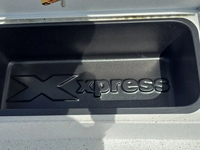 Slide: The Image of Interior view of a 2026 Xpress SW20B boat with embossed logo in storage compartment. - 32