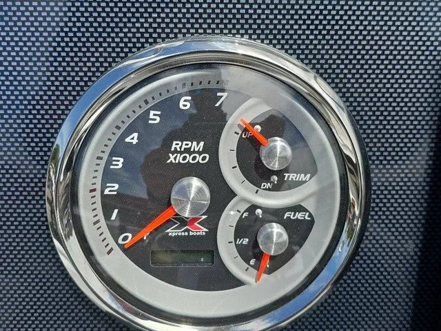 Slide: The Image of A tachometer with RPM gauge, trim indicator, and fuel gauge on a textured background. - 29