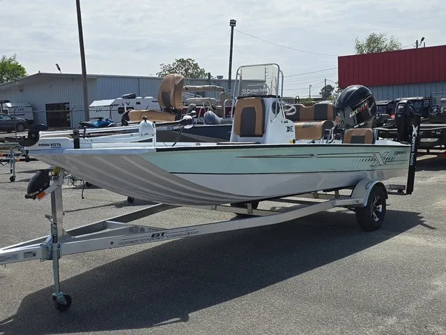 Slide: The Image of A 2026 Xpress SW20B boat on a trailer, featuring an outboard motor and steering console. - 2