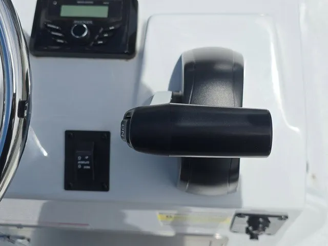 Slide: The Image of Close-up of the throttle and controls on an Xpress SW20B boat. - 25