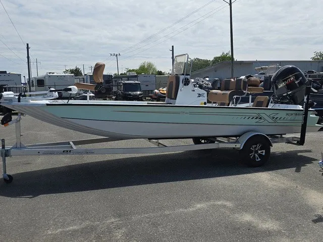 Slide: The Image of A 2026 Xpress SW20B boat on a trailer, featuring an outboard motor and multiple seats. - 4