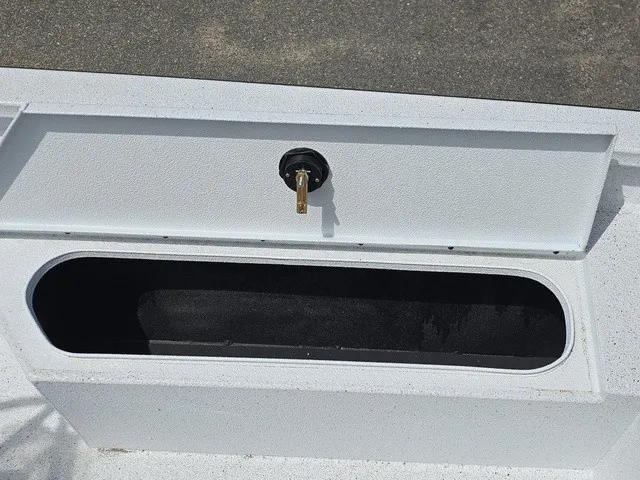 Slide: The Image of An open storage compartment on a boat with a black interior. - 31