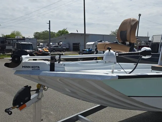 Slide: The Image of An Xpress SW20B boat with a Minn Kota Maxxum motor, parked on a trailer. - 17