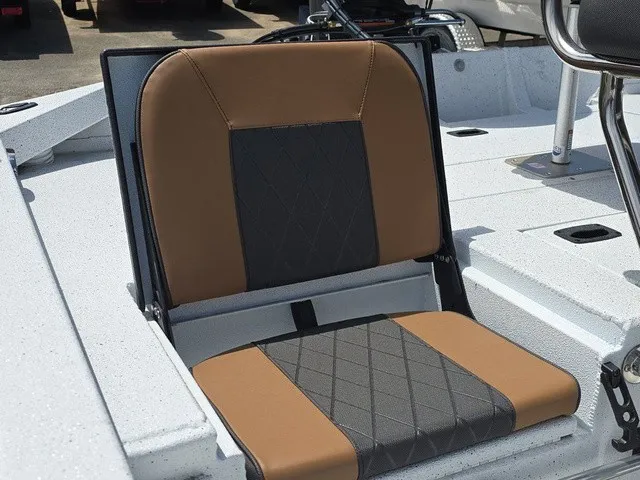 Slide: The Image of A stylish seat with brown and black upholstery on an Xpress SW20B boat. - 22