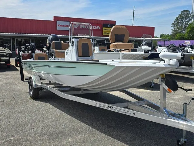 Slide: The Image of A 2026 Xpress SW20B boat on a trailer in front of a store. - 14