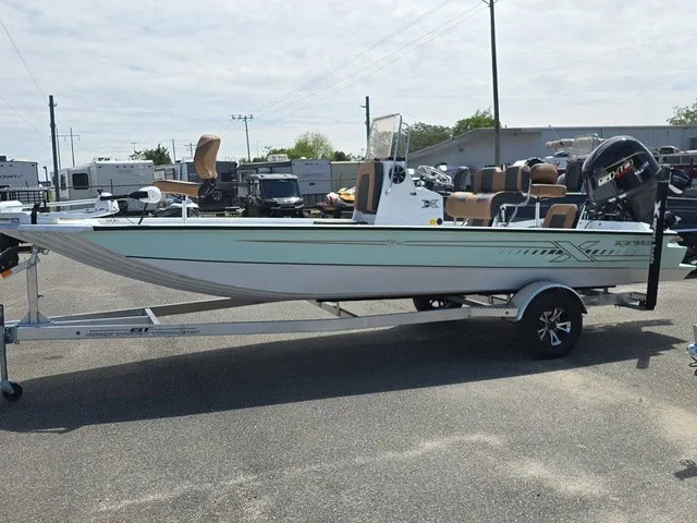 Slide: The Image of A 2026 Xpress SW20B boat on a trailer, featuring an outboard motor and multiple seats. - 3