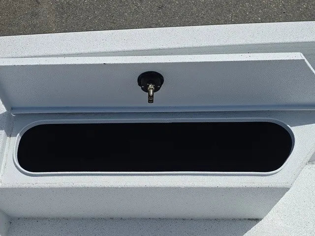 Slide: The Image of An open storage compartment on a 2026 Xpress SW20B boat, featuring a lock on the lid. - 33