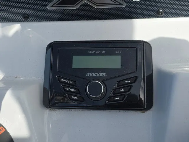 Slide: The Image of A Kicker media center is installed in a boat dashboard, surrounded by white surfaces. - 24