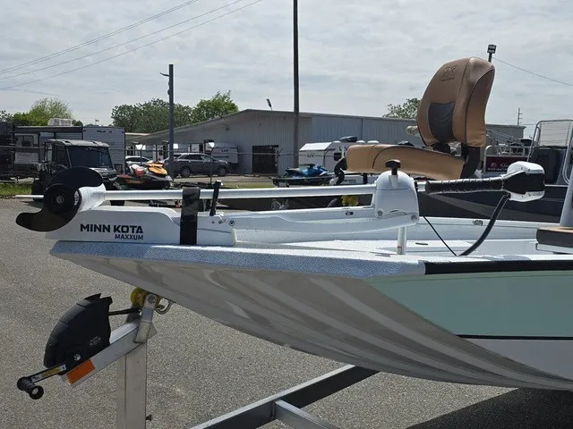 Slide: The Image of A 2026 Xpress SW20B boat on a trailer, featuring a Minn Kota motor and beige seat. - 18