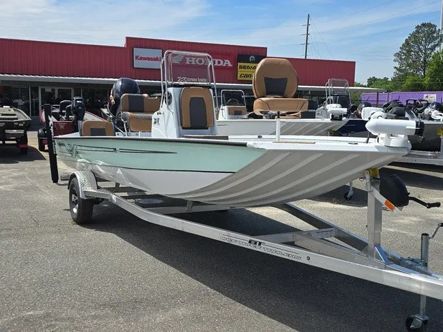 Slide: The Image of A 2026 Xpress SW20B boat on a trailer in front of a store. It features a green and white paint job. - 15