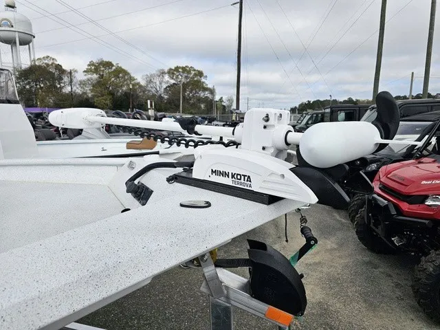 Slide: The Image of An Xpress XP20CC boat with a Minn Kota Terrova motor on a trailer, surrounded by vehicles. - 12