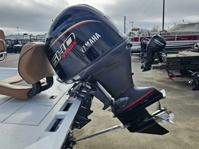 Slide: The Image of A Yamaha outboard motor is mounted on an Xpress XP20CC boat, which is on a trailer. - 30