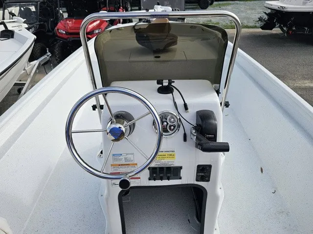 Slide: The Image of The image shows the helm of a 2026 Xpress XP20CC boat with a steering wheel and instruments. - 23