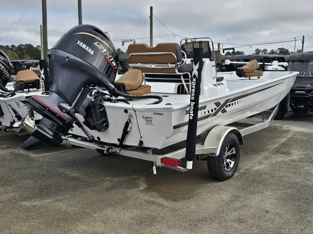 Slide: The Image of A 2026 Xpress XP20CC boat with a Yamaha outboard motor, parked on a trailer. - 5