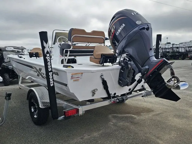 Slide: The Image of A 2026 Xpress XP20CC boat on a trailer with a Yamaha outboard motor. - 7
