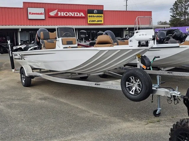 Slide: The Image of A 2026 Xpress XP20CC boat on a trailer in front of a dealership. - 3