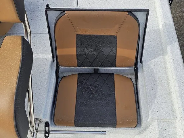 Slide: The Image of A boat seat with brown and black upholstery featuring a diamond pattern on a white deck. - 21