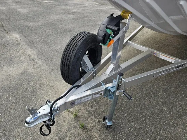 Slide: The Image of A boat trailer with a spare tire and hitch on a paved surface. - 9