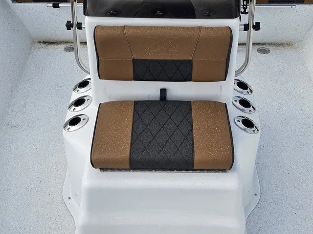 Slide: The Image of The 2026 Xpress XP20CC features a cushioned seat with cup holders on a white deck. - 16