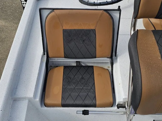 Slide: The Image of A seat with brown and black upholstery in a boat. - 19