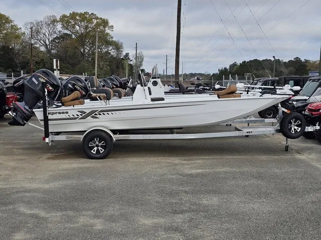 Slide: The Image of A white 2026 Xpress XP20CC boat on a trailer, surrounded by other vehicles. - 4