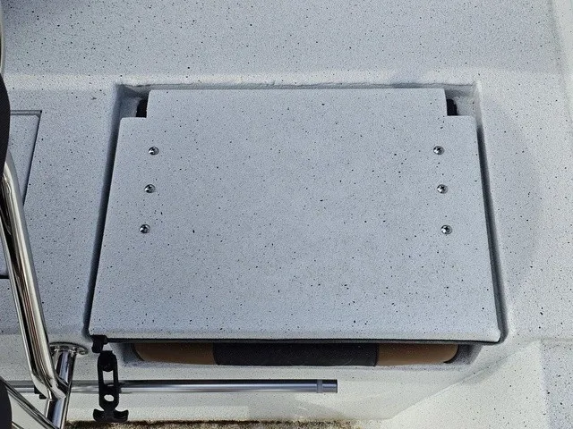 Slide: The Image of A gray, cushioned seat on a boat with metal brackets and a non-slip surface. - 20