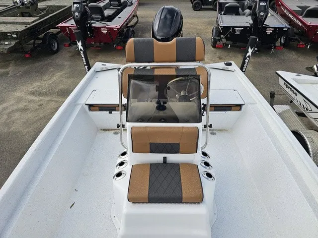Slide: The Image of The image shows the cockpit of an Xpress XP20CC boat with cushioned seats and a steering console. - 15