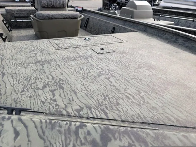 Slide: The Image of The image shows the deck of a Tracker Grizzly 1860 CC boat with a textured camouflage pattern. - 5